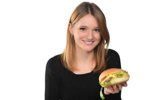 portrait of a beautiful funny young girl eating hamburger photo