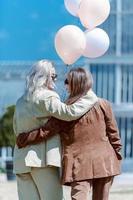 LGBT Lesbian couple love moments. Lesbian couple holding balloons in the park. Happiness concept photo