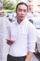 ASIAN business male model talking on his cell phone photo