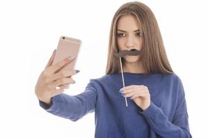 Beauty funny teenage girl making selfie with her cellphone photo