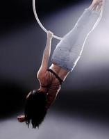 A female Aerial hoop gymnast  performing exercises on an Aerial hoop photo