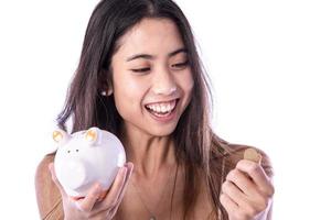 Asian woman saving money in piggy bank photo