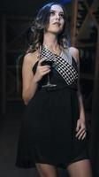 female fashionable model holding glass of wine. woman drinking wine. photo