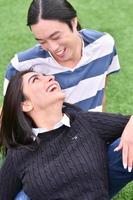 Mixed Couple relaxing In the park photo