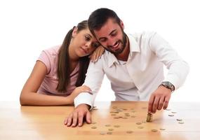Family savings concept. Beautiful couple home financing. Saving money in the piggy bank. photo