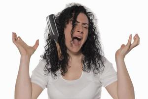 beautiful female with comb stuck in curly hair photo