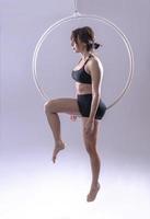 A female Aerial hoop gymnast  performing exercises on an Aerial hoop photo