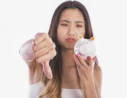 Asian woman saving money in piggy bank photo