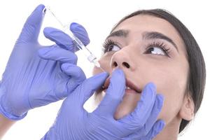 young woman gets injection of botox. anti-aging injection photo