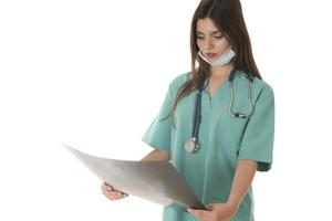 Young female doctor looking at the x-ray picture. isolated on white photo