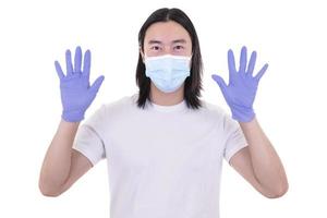 Asian male model wearing and holding surgical face mask and protective gloves photo