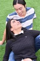 Mixed Couple relaxing In the park photo