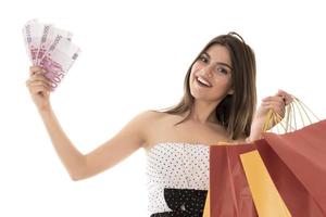 Young Modern Beautiful woman with a lot of shopping bags and money photo