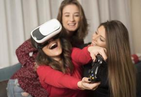 friends playing video games wearing virtual reality glasses photo