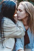 A couple of gay woman smiling and kissing. Same sex young married female couple in their daily routine showing some affection LGBT photo