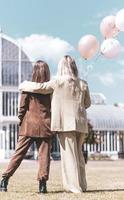 LGBT Lesbian couple love moments. Lesbian couple holding balloons in the park. Happiness concept photo