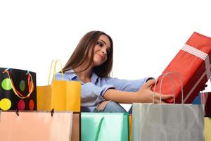 Beautiful smiling brunette with shopping bags. Shopping concept in studio photo