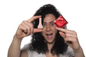 woman holding condom. save sex concept photo