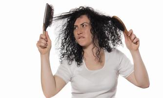 beautiful female with comb stuck in curly hair photo