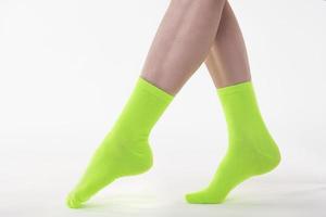 Nice attractive feminine long legs wearing green socks photo