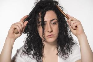 beautiful female with comb stuck in curly hair photo