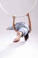 A female Aerial hoop gymnast  performing exercises on an Aerial hoop photo