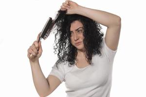 beautiful female with comb stuck in curly hair photo