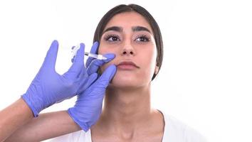 young woman gets injection of botox. anti-aging injection photo