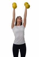 Determined woman losing weight and exercising with dumbbells photo