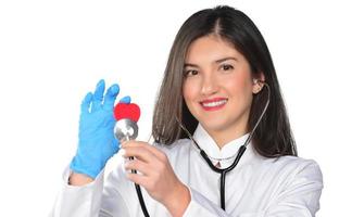 cardio heart surgeon hands holding red heart shape on white background photo