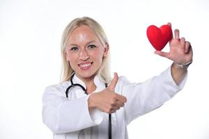 cardio heart surgeon hands holding red heart shape on white background photo