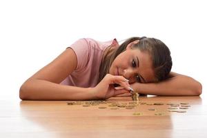 Young brunette women collecting metal money. savings finance concept photo