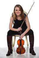 Beautiful natural blond girl holding and playing violin. photo