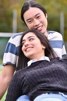 Mixed Couple relaxing In the park photo
