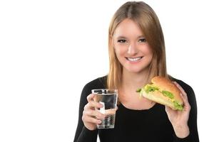 portrait of a beautiful funny young girl eating hamburger photo