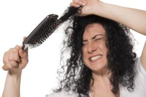 beautiful female with comb stuck in curly hair photo