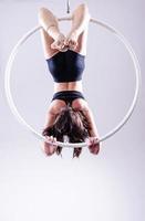 A female Aerial hoop gymnast  performing exercises on an Aerial hoop photo