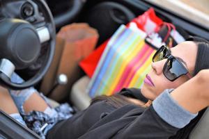 feliz hermosa joven rubia conduciendo un coche deportivo en la ciudad foto