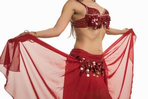 Beautiful belly dancer young woman in gorgeous red costume dress photo