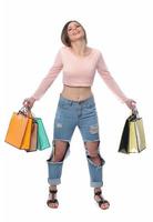 Image of a beautiful young brunette lady posing with shopping bags and looking at camera. shopping concept. Isolated photo