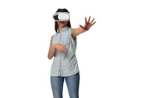Pretty cute excited female in VR headset looking up and trying to touch objects in virtual reality photo