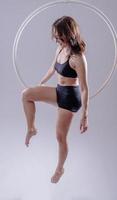 A female Aerial hoop gymnast  performing exercises on an Aerial hoop photo