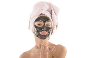 Beautiful girl with black facial cosmetic mask. Beauty concept. isolated photo