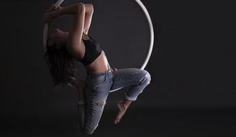 A female Aerial hoop gymnast  performing exercises on an Aerial hoop photo