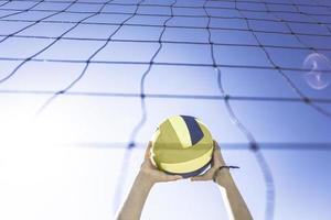 Kid plays volleyball on beautiful summer day photo