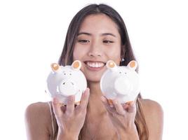 Asian woman saving money in piggy bank photo
