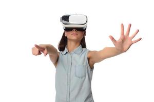 Pretty cute excited female in VR headset looking up and trying to touch objects in virtual reality photo