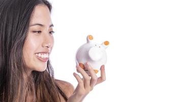 Asian woman saving money in piggy bank photo