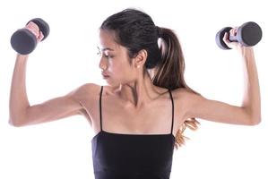 young sporty Asian woman with dumbbells photo