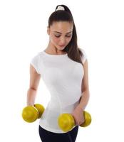 Determined woman losing weight and exercising with dumbbells photo